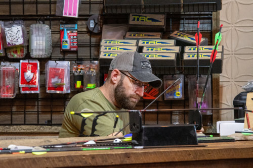 Casey Votruba meticulously crafting an arrow